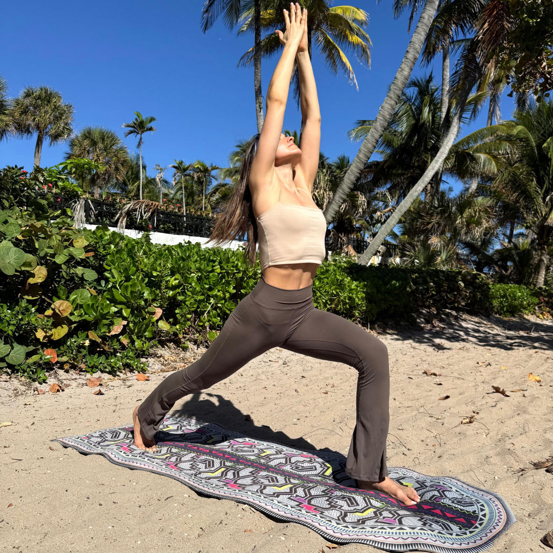 Yoga practitioner using Kené Mat during hot yoga class, showcasing its excellent grip and eco-friendly material.